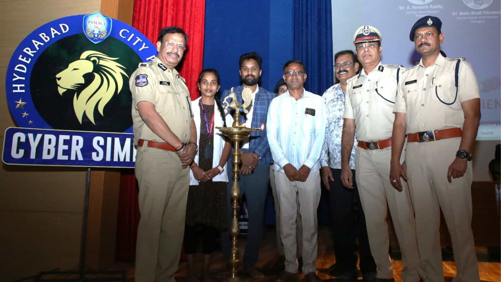 Police officers and volunteers at Hyderabad cybercrime awareness event.