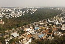 This image shows the Gurramguda region in Telangana, recently declared a reserve forest, with urban development and lush greenery visible from above.