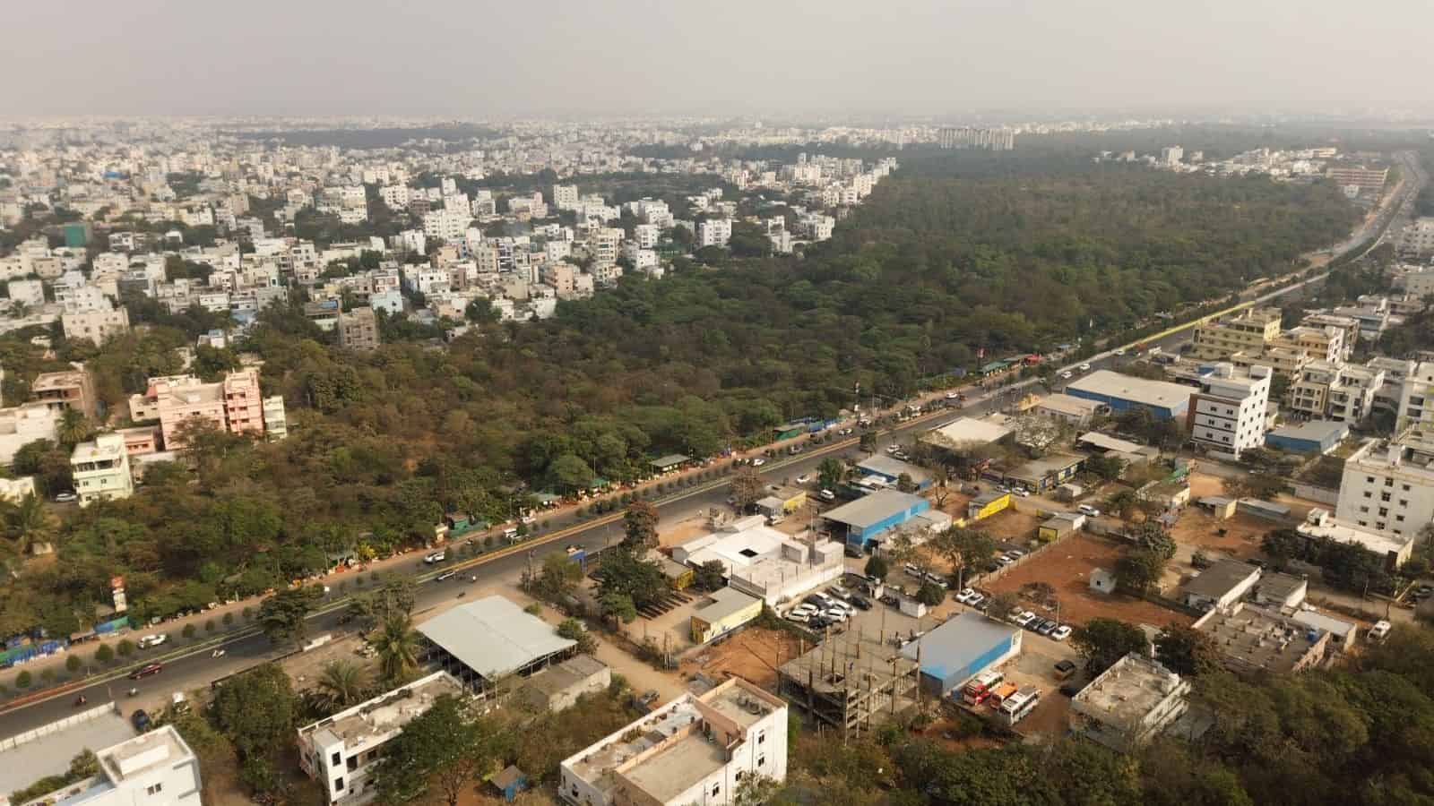 This image shows the Gurramguda region in Telangana, recently declared a reserve forest, with urban development and lush greenery visible from above.