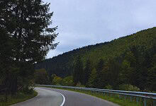 Scenic mountain highway with lush green trees and a winding road, set to be completed by December, linkin.