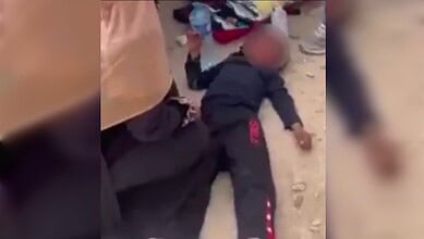 Deported Jewish-American man lying on the ground after witnessing a Palestinian child hit by a car in Wes.