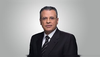 Jamal Rayyan, veteran Al Jazeera journalist, in a formal portrait wearing a suit and tie.