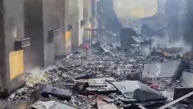 Explosion aftermath at a factory in Nagpur, with debris and smoke.