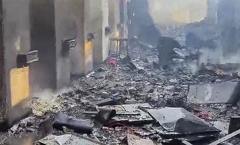 Explosion aftermath at a factory in Nagpur, with debris and smoke.