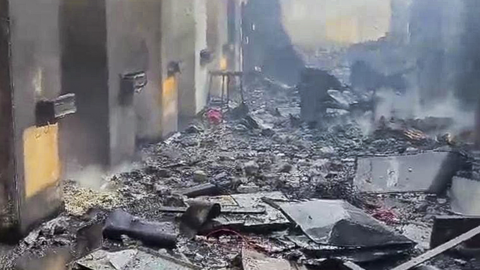 Explosion aftermath at a factory in Nagpur, with debris and smoke.