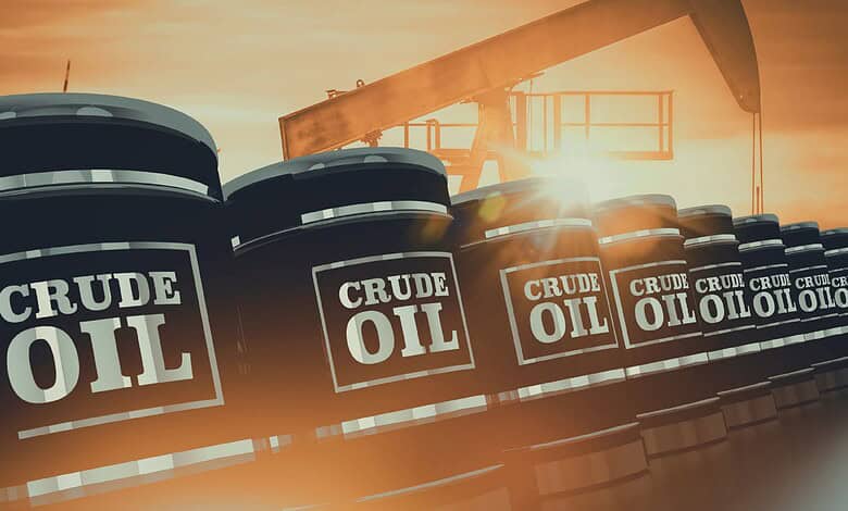 Oil storage tanks with "Crude Oil" labels against sunset sky, symbolising stable oil supplies amid Gulf t.