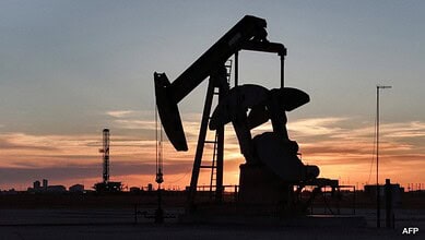 Oil pumpjack silhouetted against a sunset sky, highlighting energy sector impacts amid rising oil prices.