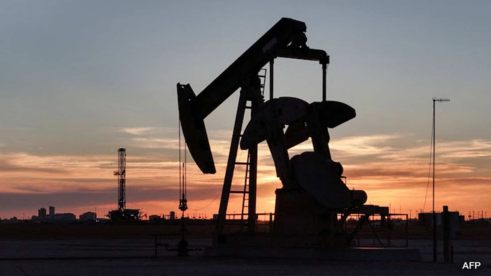 Oil pumpjack silhouetted against a sunset sky, highlighting energy sector impacts amid rising oil prices.