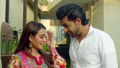 Pakistani drama actors smiling and interacting on set, showcasing vibrant costumes and chemistry.