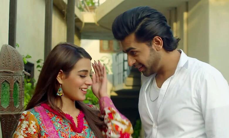 Pakistani drama actors smiling and interacting on set, showcasing vibrant costumes and chemistry.