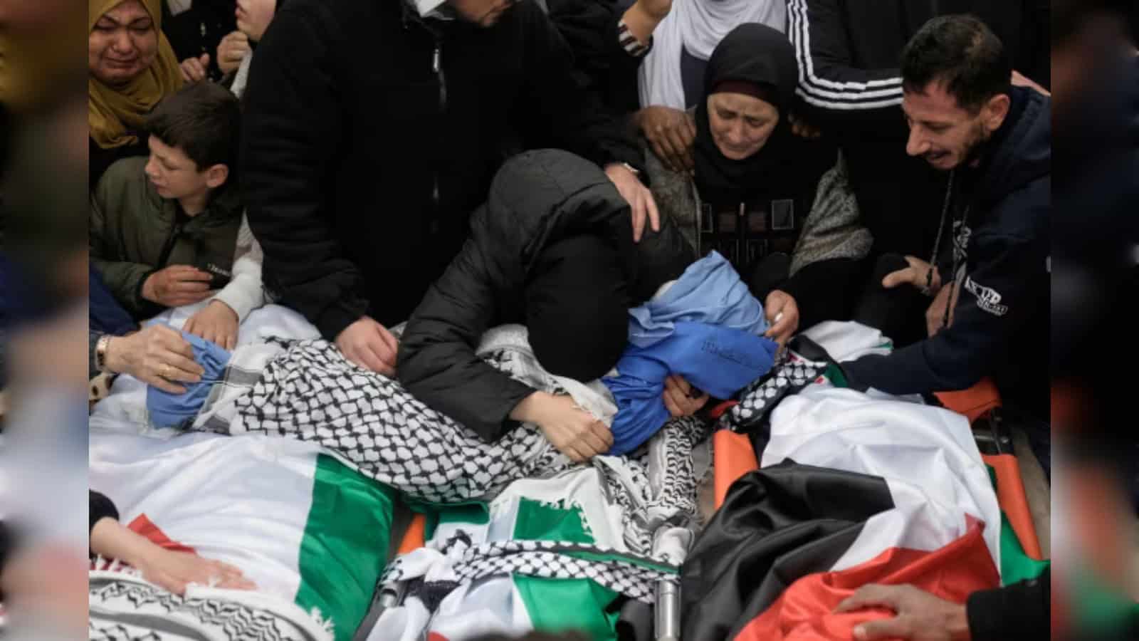 People assisting a person in distress at a crowded event, showing compassion and urgency.