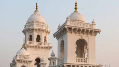 The restored historic Town Hall with white façade and ornate domes, now serving as the Legislative Counci.