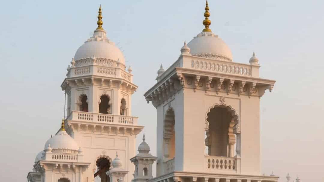 The restored historic Town Hall with white façade and ornate domes, now serving as the Legislative Counci.