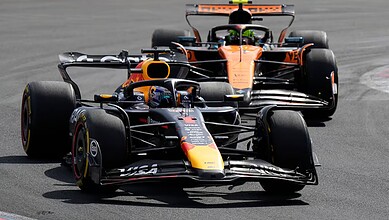 F1 race cars racing on the track, highlighting motorsport and Formula 1 events.