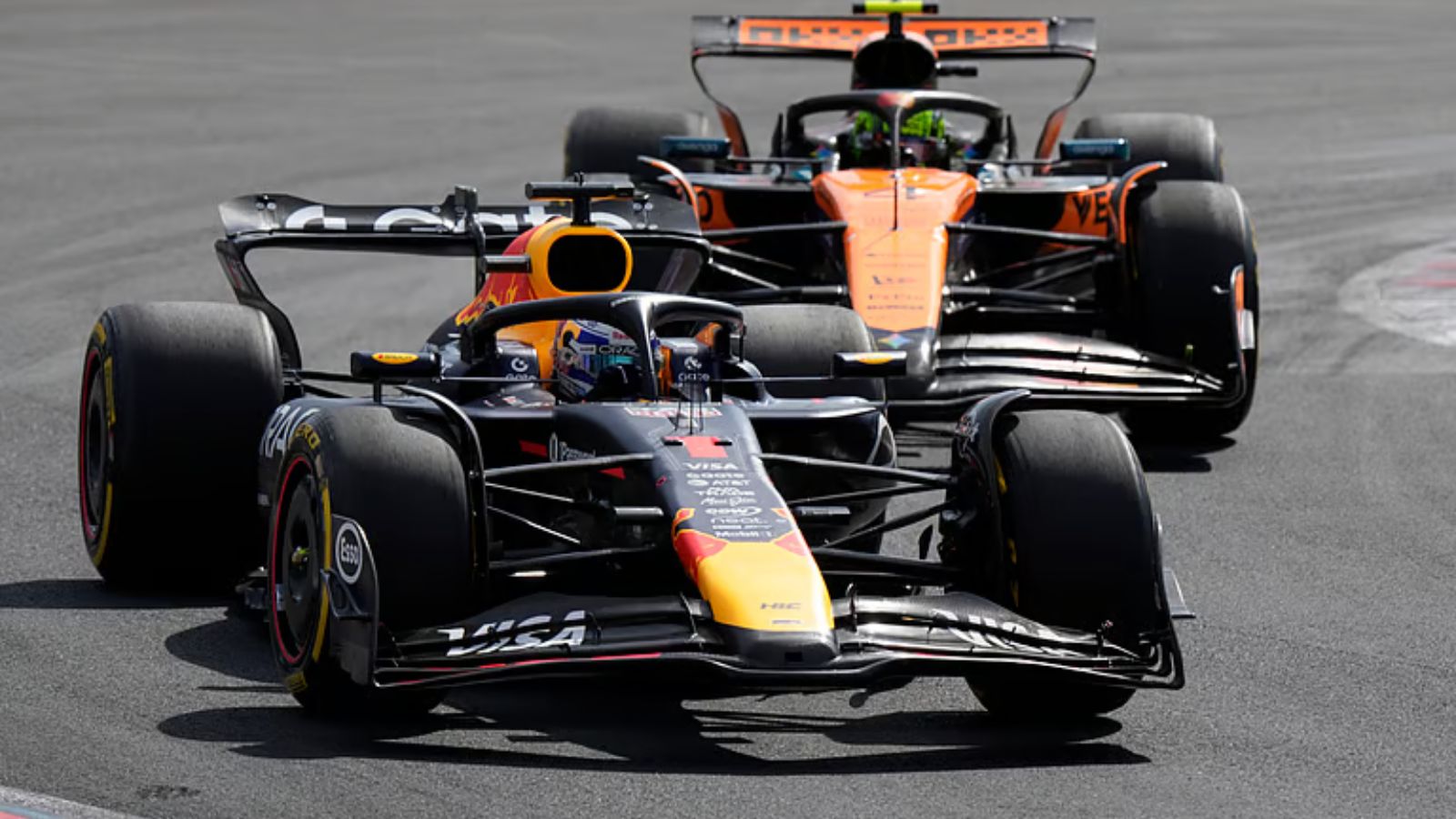 F1 race cars racing on the track, highlighting motorsport and Formula 1 events.