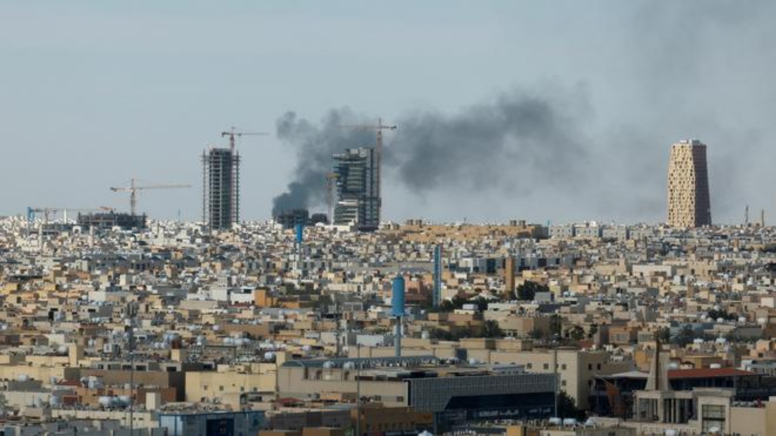 Smoke rising over Riyadh skyline during heightened tensions linked to the US-Israel conflict with Iran in Saudi Arabia.