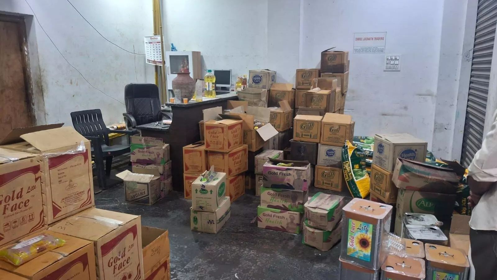 Seized adulterated cooking oil and wheat flour worth Rs 21 lakh in Hyderabad, displayed in a storage room.