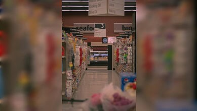 Supermarket aisle with stocked shelves as UAE assures supply of essential goods.