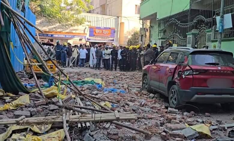 Scaffolding collapse incident in Tolichowki with rescue teams and onlookers at the scene.