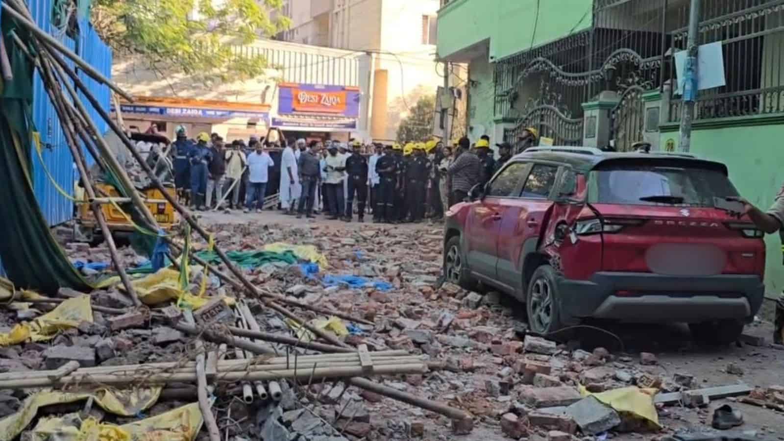 Scaffolding collapse incident in Tolichowki with rescue teams and onlookers at the scene.