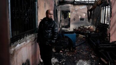 Man surveys fire-damaged home after settler attack in West Bank village