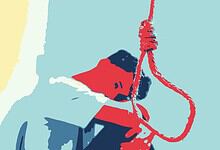 Person hanging from a red rope with a black object, possibly a rescue or safety scenario.