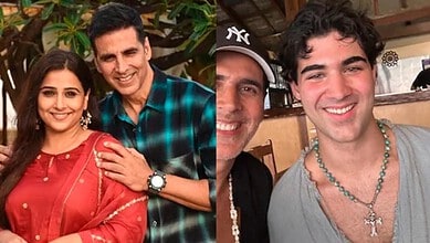 Young man with a necklace, smiling, in a casual setting.