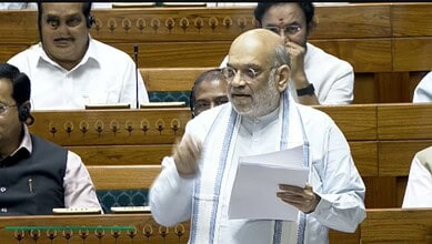 Indian politician Amit Shah speaking passionately during opposition protest in parliament.