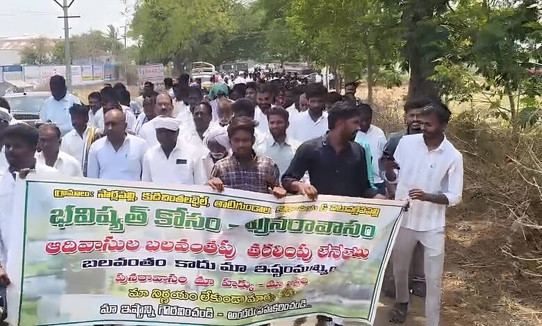 Protesters gather with banners demanding government action for village relocation from tiger reserve area.