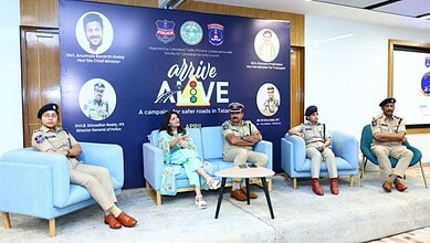 Road safety campaign in Telangana featuring police officers and community leaders discussing traffic safe.