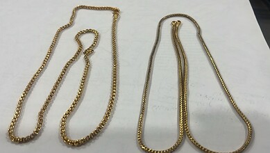 Gold mangalsutra necklaces with black beads, traditional Indian jewellery.