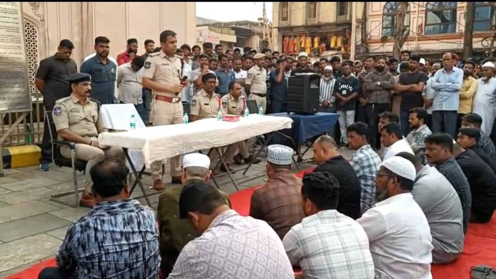 Police officials addressing shopkeepers during a raid on illegal 'hidden tax' practices.