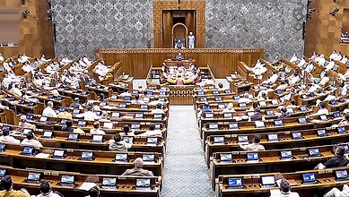 Parliament session with MPs discussing the Constitution amendment bill amid protests.