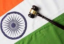 Gavel resting on Indian flag representing constitutional amendments and legal authority.