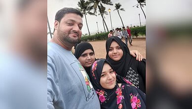 Family enjoying a day outdoors at the beach with palm trees in the background.