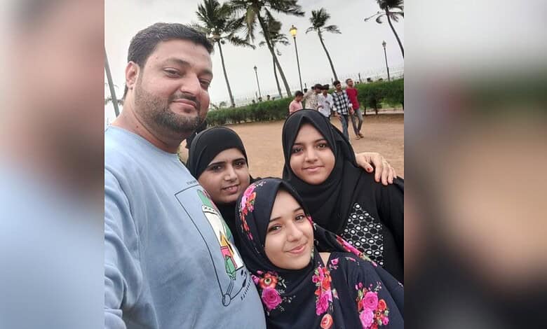 Family enjoying a day outdoors at the beach with palm trees in the background.