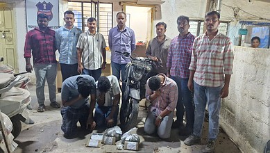 Arrested suspects with seized ganja in Rangareddy, police showcase the drug bust and apprehended individu.