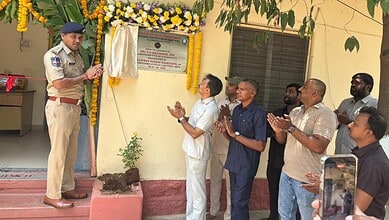 Police officer unveiling a plaque during a ceremony in Hyderabad.