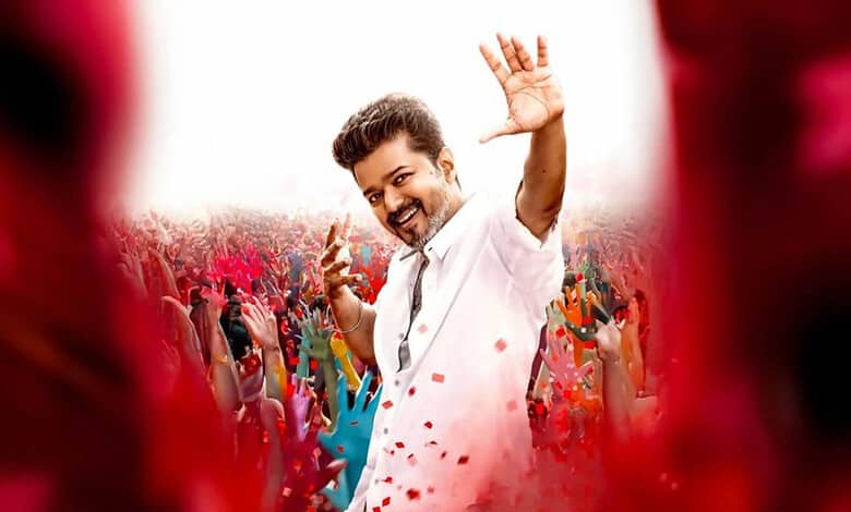 Thalapathy Vijay celebrating Holi with fans, colourful powders, joyful atmosphere, Tamil cinema star.