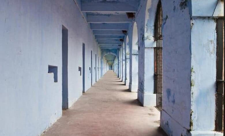 Long blue corridor at Hyderabad Police station with barred windows and doors.