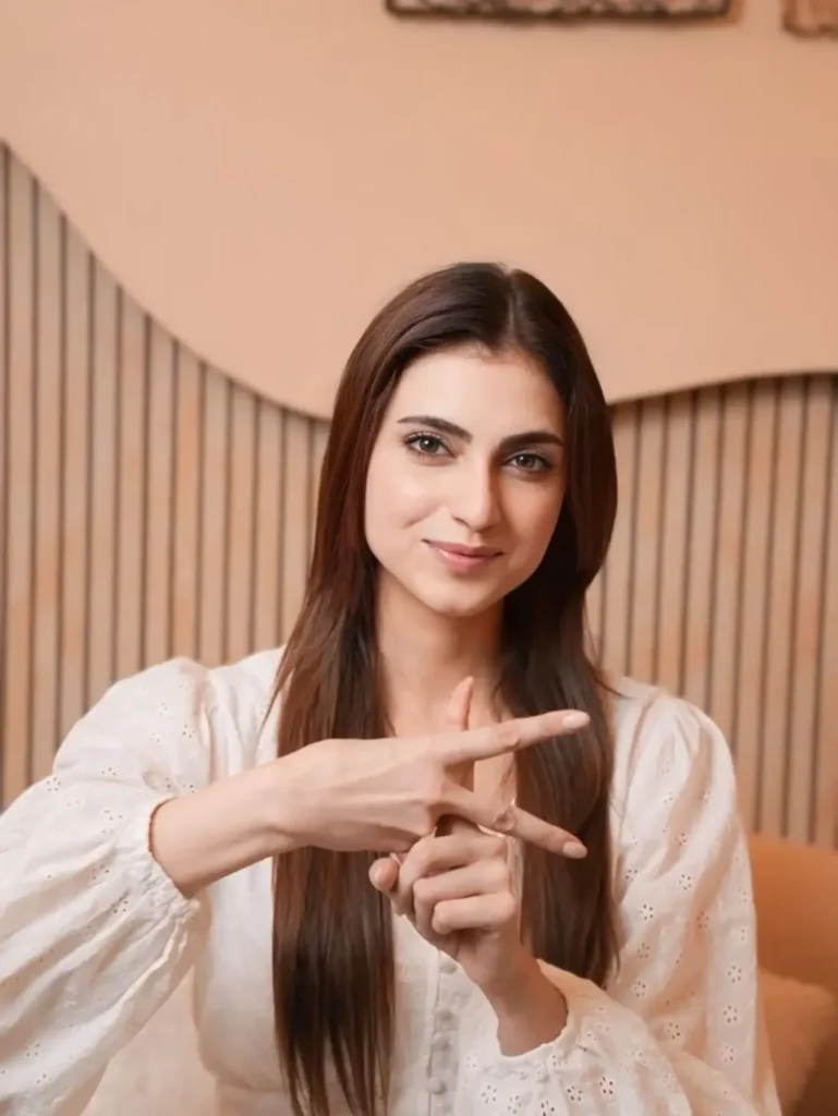 Female contestant of Khatron Ke Khiladi 15 showing a peace sign with her fingers.