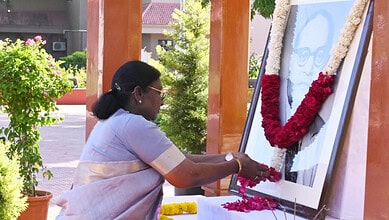 President Murmu offering flowers at a portrait of B R Ambedkar during his birth anniversary commemoration.