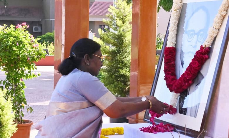 President Murmu offering flowers at a portrait of B R Ambedkar during his birth anniversary commemoration.