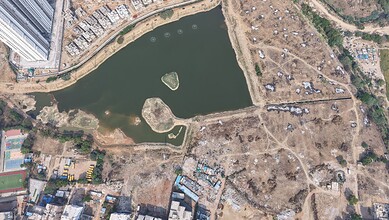 Aerial view of Muskin Cheruvu FTL with dry areas and water body, as Hydraa demands residents vacate withi.