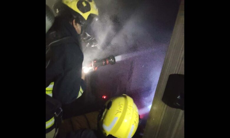 Firemen inspect the damage at the AC unit in Hyderabad
