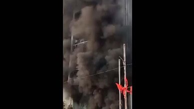 Smoke and flames erupt from a Gachibowli apartment after a fire breaks out.