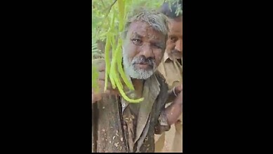 Elderly man being rescued from a lake in Hyderabad, assisted by rescue workers after a fall.
