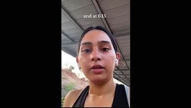 Woman recording video outdoors under shelter, close-up shot.