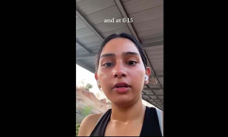 Woman recording video outdoors under shelter, close-up shot.