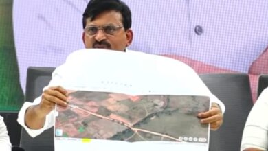 The image shows Revenue Minister Ponguleti Srinivasa Reddy showing google earth images of the road and shed constructions in 373 acres of government land in Nadergul village between 2021 and 2022.